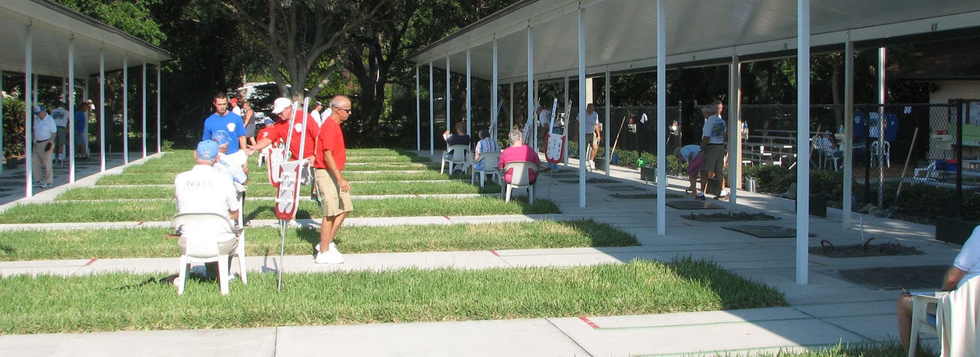 Members pitching horseshoes under the covered courts at Ed Wright Park